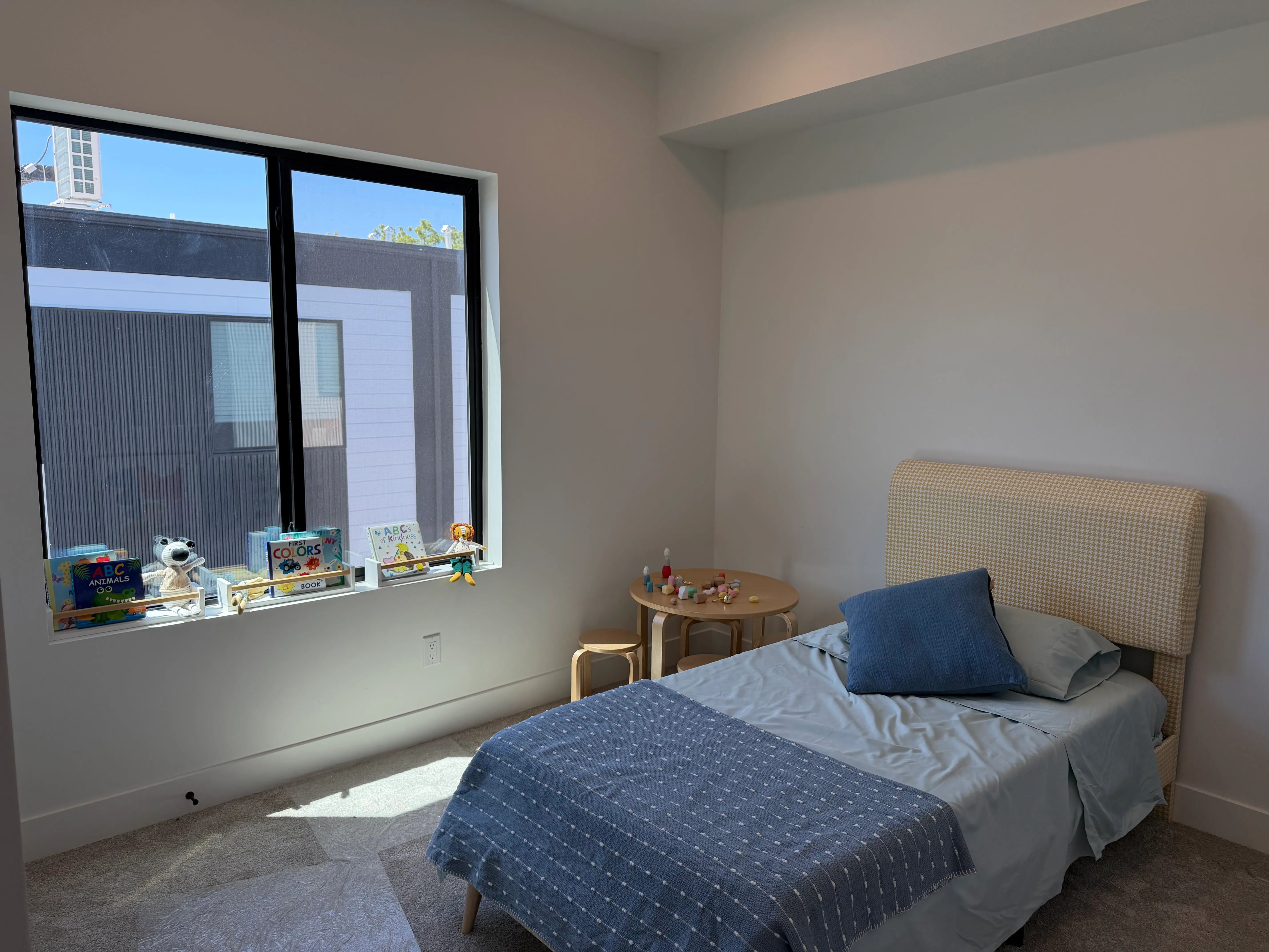 Second bedroom furnished with a twin bed and a large sunny window